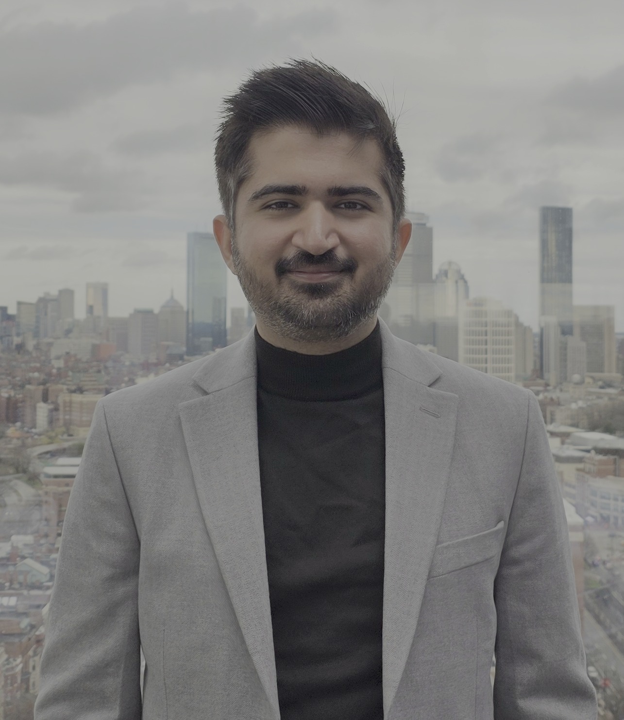 Harshul Chugh standing in front of the Boston skyline